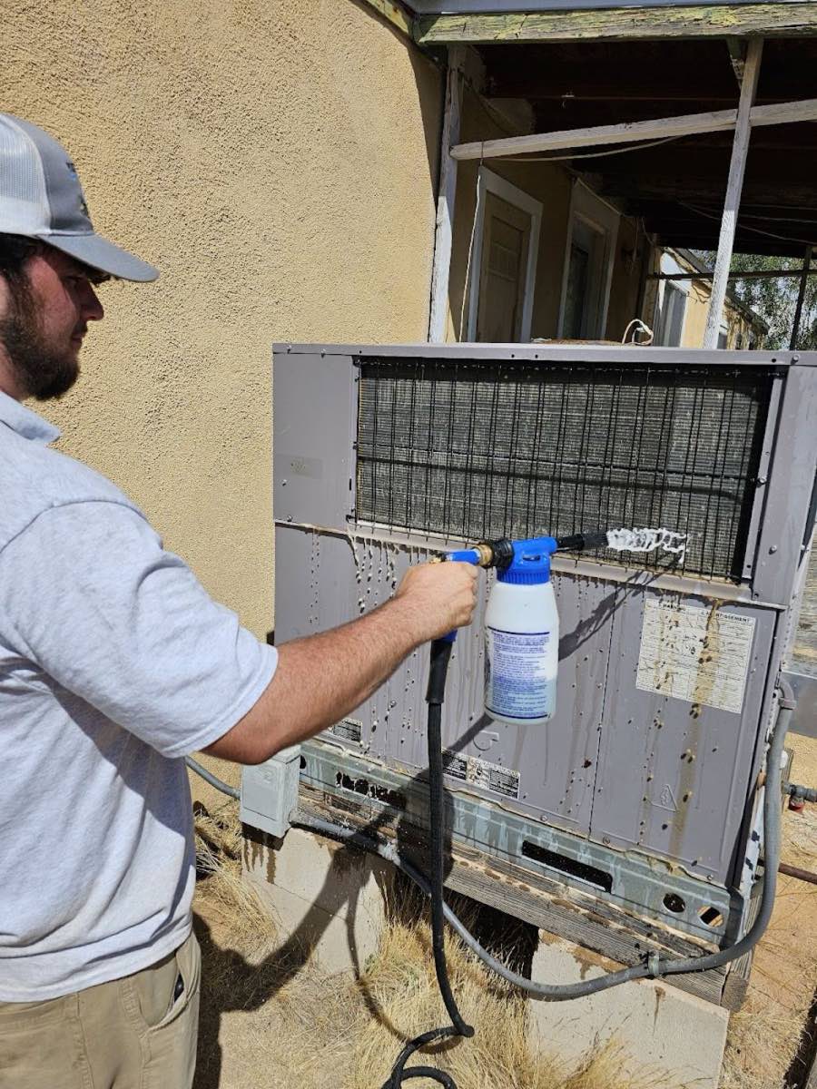 Picture Rocks technician cleaning an outdoor HVAC coil at a Tucson home